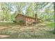 Classic brick home exterior with a chimney and landscaping, set on a spacious lot at 775 Old Graham Rd, Pittsboro, NC 27312