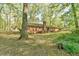 Brick house exterior, featuring a classic design, chimney, and natural surroundings at 775 Old Graham Rd, Pittsboro, NC 27312