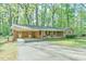 Charming brick home with carport, front porch, and lush green lawn at 775 Old Graham Rd, Pittsboro, NC 27312