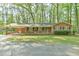 Charming brick home with carport, front porch, and lush green lawn at 775 Old Graham Rd, Pittsboro, NC 27312