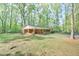 Charming brick home with carport, front porch, and lush green lawn at 775 Old Graham Rd, Pittsboro, NC 27312