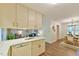 Open kitchen view with white countertops, white appliances, and sight lines to dining area at 775 Old Graham Rd, Pittsboro, NC 27312