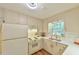 Charming kitchen with white cabinets, quartz countertops, and stainless steel appliances at 775 Old Graham Rd, Pittsboro, NC 27312