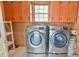 Bright laundry room with modern appliances and ample cabinet space at 775 Old Graham Rd, Pittsboro, NC 27312