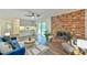 Open-concept living room with fireplace, kitchen access, and large sliding glass doors to the outside at 775 Old Graham Rd, Pittsboro, NC 27312