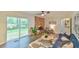 Comfortable living room with large windows, fireplace, modern ceiling fan, and stylish furniture at 775 Old Graham Rd, Pittsboro, NC 27312