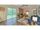 Inviting living room featuring large windows, a brick fireplace, a fan, and modern furnishings at 775 Old Graham Rd, Pittsboro, NC 27312