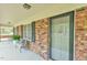 Charming front porch with brick accents and outdoor seating perfect for relaxing at 775 Old Graham Rd, Pittsboro, NC 27312