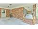 Covered porch area with brick siding and ample space for outdoor living at 775 Old Graham Rd, Pittsboro, NC 27312