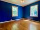 Unfurnished bedroom featuring hardwood floors, light colored trim, and a window at 810 Nancy St, Durham, NC 27701