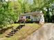Exterior home view with beautiful landscaping including azaleas and mature trees at 810 Nancy St, Durham, NC 27701