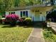 Charming one-story home with a well-maintained lawn and colorful, mature landscaping at 810 Nancy St, Durham, NC 27701