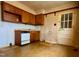 Traditional kitchen with wood cabinets, white appliances, and a back door at 810 Nancy St, Durham, NC 27701
