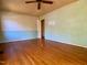 Unfurnished living room featuring hardwood floors, light colored paint and ceiling fan at 810 Nancy St, Durham, NC 27701