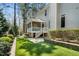 A lush backyard featuring a screened porch and manicured landscaping providing a private oasis for outdoor living and entertaining at 83 Calabria Ct, Clayton, NC 27527