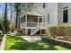 A lush backyard featuring a screened porch and manicured landscaping providing a private oasis for outdoor living and entertaining at 83 Calabria Ct, Clayton, NC 27527