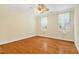 Bright bedroom with hardwood floors, ceiling fan, and natural light from two windows at 83 Calabria Ct, Clayton, NC 27527