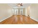 Bright bedroom with hardwood floors, ceiling fan, and plenty of natural light from two windows at 83 Calabria Ct, Clayton, NC 27527