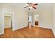 Cozy bedroom with hardwood floors, a ceiling fan, and access to a closet and a bathroom at 83 Calabria Ct, Clayton, NC 27527