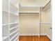 Walk-in closet with built-in shelving and hardwood floors provides ample storage space at 83 Calabria Ct, Clayton, NC 27527