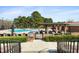 Inviting community pool area with ample seating, a shaded pergola, and a well-maintained deck at 83 Calabria Ct, Clayton, NC 27527