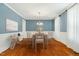 Elegant dining room with hardwood floors, wainscoting, and a stylish chandelier at 83 Calabria Ct, Clayton, NC 27527