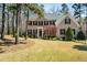 Brick home with black shutters, a green lawn, and a colorful tree in the front yard at 83 Calabria Ct, Clayton, NC 27527