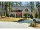 Traditional brick home with a manicured lawn, flowering trees, and driveway at 83 Calabria Ct, Clayton, NC 27527