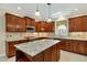 Kitchen with granite countertops, stainless appliances, a center island, and bright lighting at 83 Calabria Ct, Clayton, NC 27527