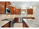Stylish kitchen featuring modern appliances, granite countertops, and ample cabinet space for storage at 83 Calabria Ct, Clayton, NC 27527