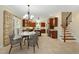Open kitchen and dining area featuring granite counters, stainless appliances, tile floors, and staircase at 83 Calabria Ct, Clayton, NC 27527