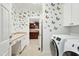 Bright laundry room with washer, dryer, sink, counter space and butterfly decals at 83 Calabria Ct, Clayton, NC 27527