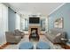 Cozy living room with fireplace, comfortable seating, and a stylish rug at 83 Calabria Ct, Clayton, NC 27527
