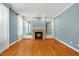 Spacious living room features a brick fireplace, hardwood floors, and built-in display cabinets at 83 Calabria Ct, Clayton, NC 27527