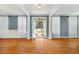 Open living room with blue walls, hardwood floors, and a view to the outdoors at 83 Calabria Ct, Clayton, NC 27527