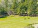 Scenic pasture with two horses grazing on lush green grass, surrounded by trees and a wooden fence at 83 Calabria Ct, Clayton, NC 27527