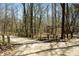 Picturesque view of the walking trail featuring signage and a bridge, perfect for outdoor adventures and exploration at 83 Calabria Ct, Clayton, NC 27527