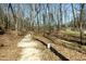 Peaceful walking trail through a wooded area, perfect for enjoying nature and a leisurely stroll at 83 Calabria Ct, Clayton, NC 27527