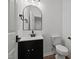 Stylish half bathroom features a modern vanity, sleek fixtures, and a decorative mirror at 834 Day Ave, Burlington, NC 27217