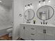 Elegant bathroom with dual sinks, decorative mirrors, and a luxurious marble-tiled shower at 834 Day Ave, Burlington, NC 27217