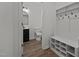 Hallway bathroom featuring a black vanity, toilet, and a bench with a coat rack at 834 Day Ave, Burlington, NC 27217