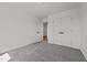 Neutral bedroom offers carpeting, a closet, and bright neutral walls at 834 Day Ave, Burlington, NC 27217