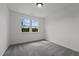 Bright bedroom with two windows and plush gray carpet for a cozy and inviting space at 834 Day Ave, Burlington, NC 27217