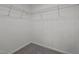 White empty walk-in closet offers carpeting and a storage system at 834 Day Ave, Burlington, NC 27217