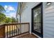 Cozy deck with stained wood and a black framed glass door at 834 Day Ave, Burlington, NC 27217