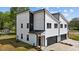 Modern two-story home with white siding, black trim, and a two-car garage offers contemporary curb appeal at 834 Day Ave, Burlington, NC 27217