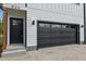 Close-up of the home's black garage door and entry featuring wood support beam at 834 Day Ave, Burlington, NC 27217