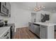 Modern kitchen with island and stainless steel appliances, and view of the stairwell at 834 Day Ave, Burlington, NC 27217