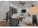 Cozy living room featuring modern furniture, wood floors, and black stair railing at 834 Day Ave, Burlington, NC 27217