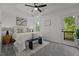 Relaxing main bedroom featuring a tray ceiling, a ceiling fan, and access to the deck at 834 Day Ave, Burlington, NC 27217